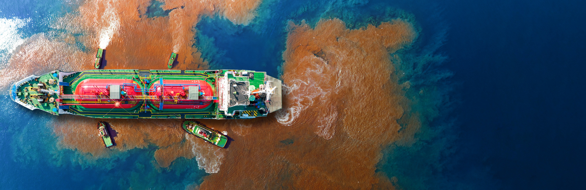 Oil leak from Ship , Oil spill pollution polluted water surface. water pollution as a result